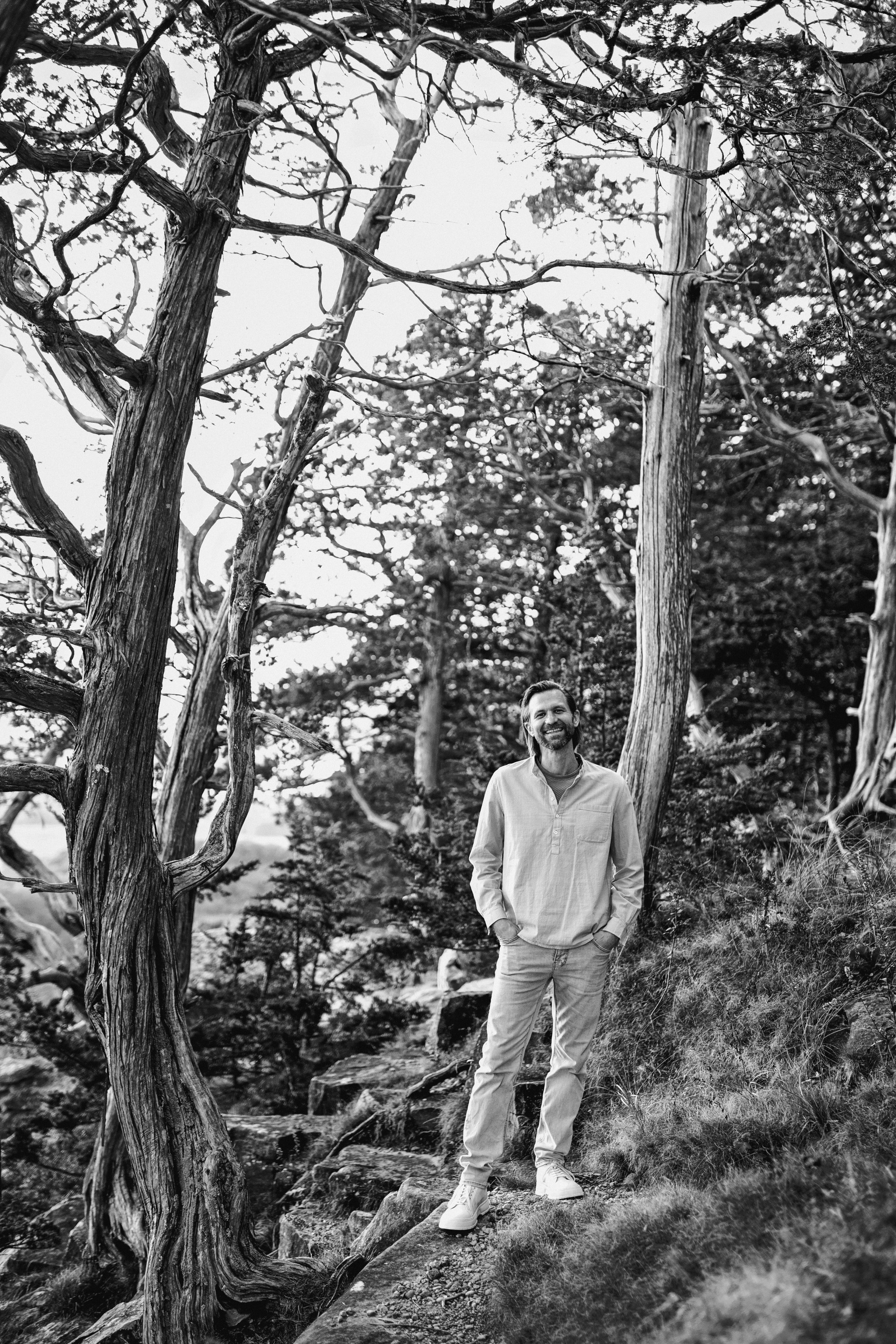 a man standing in front of trees