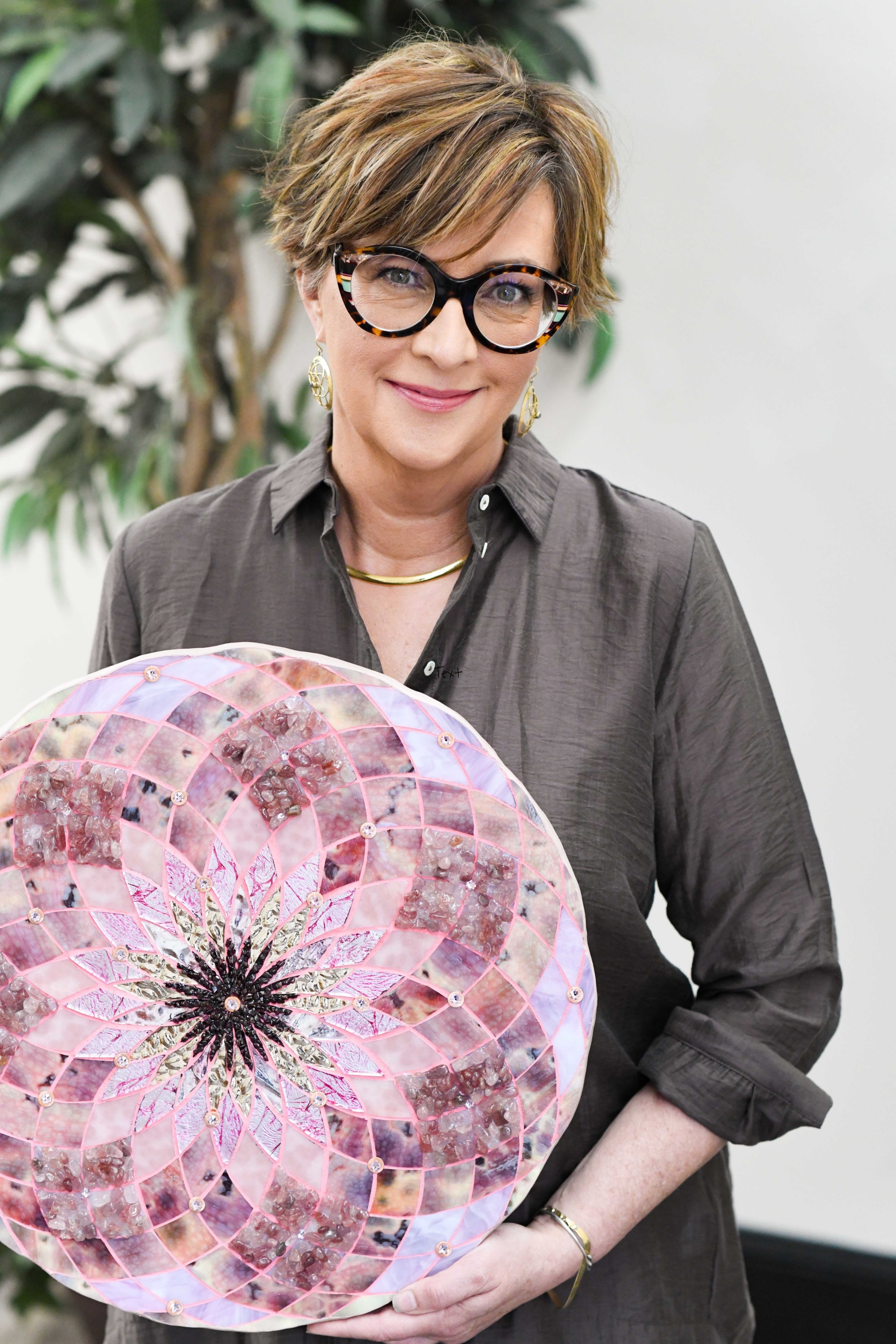 a woman holding a circular object