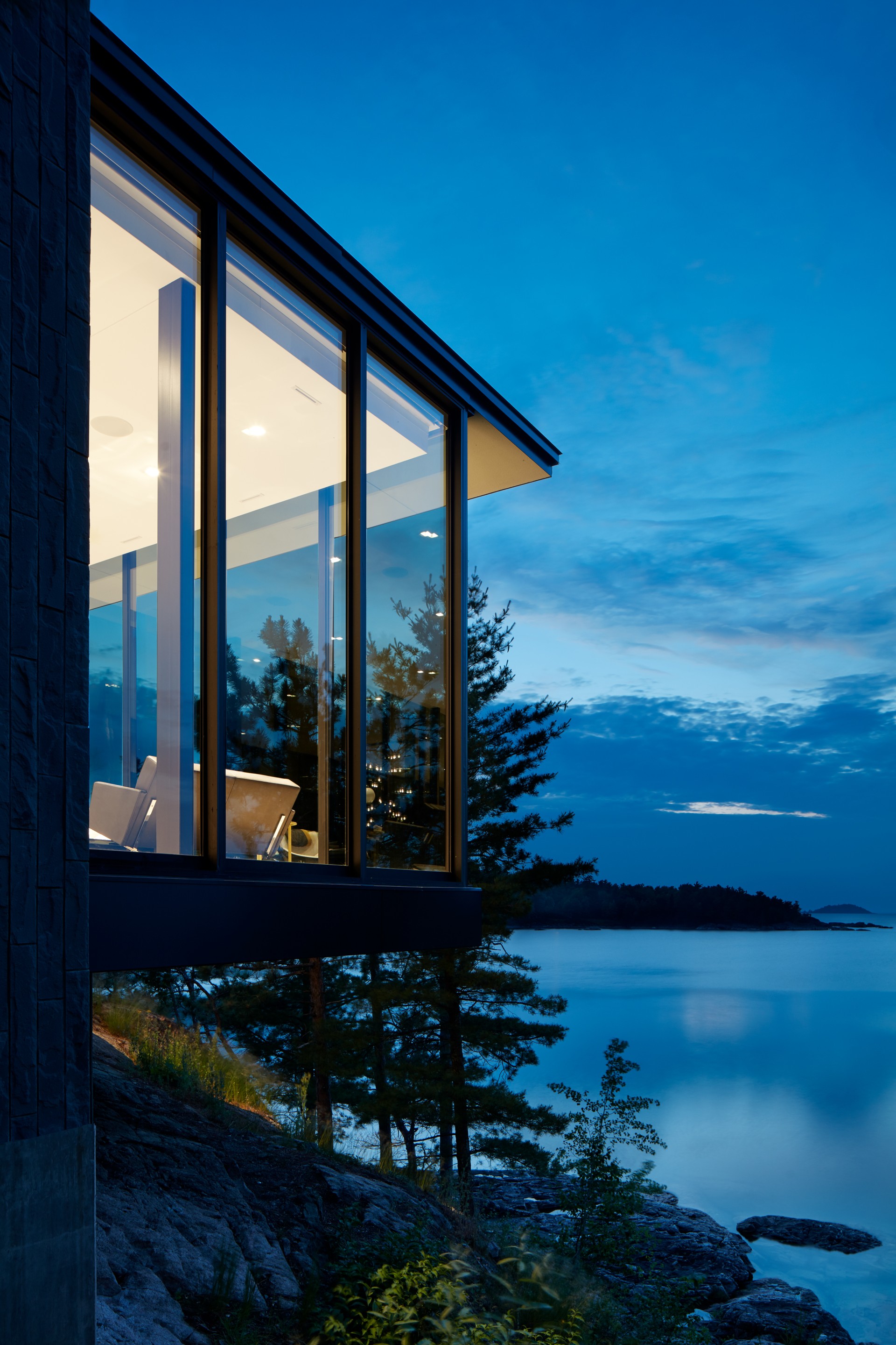 a building with a view of the water and trees