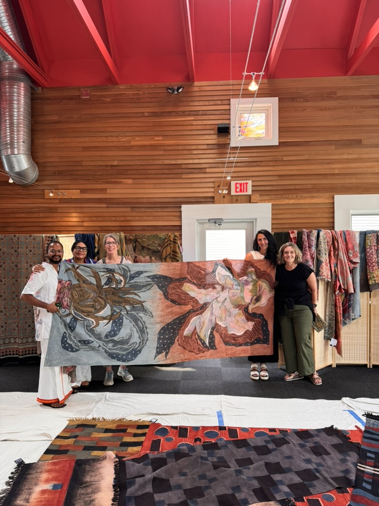 a group of people holding a large piece of fabric