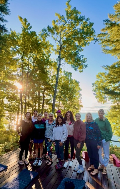 a group of women standing on a wooden platform