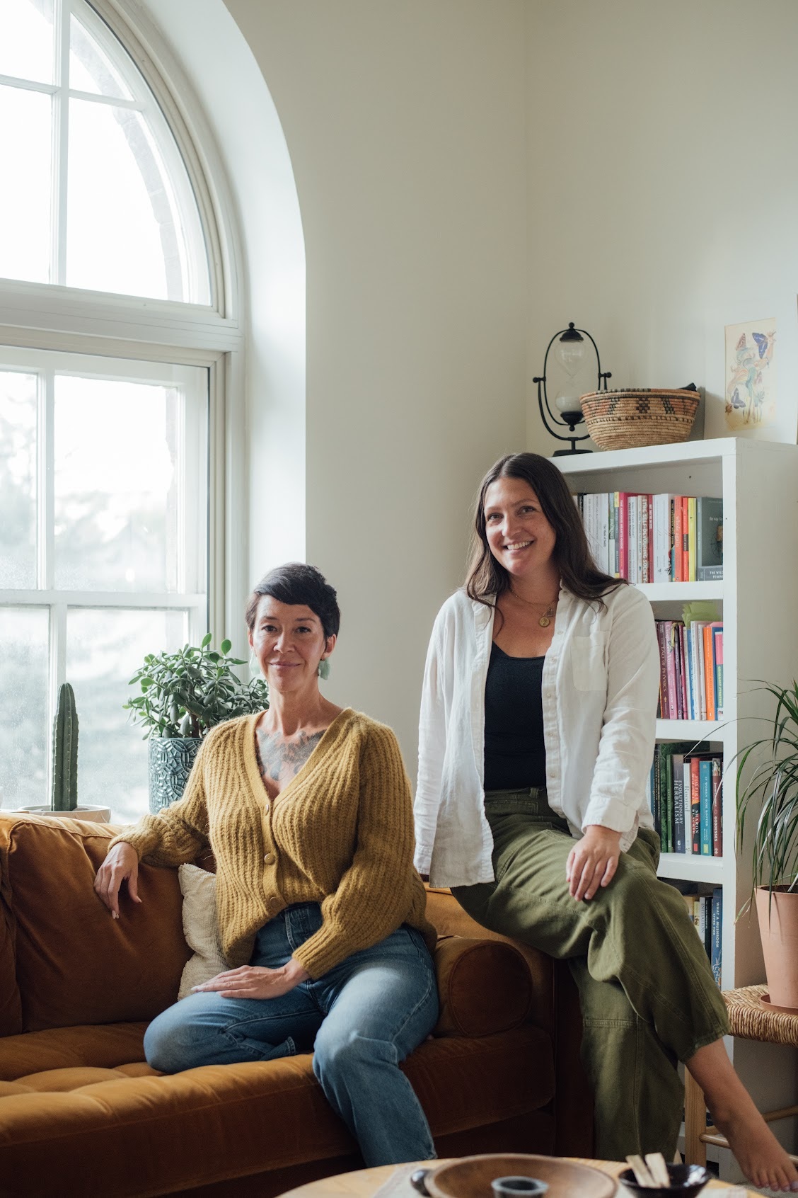 two women sitting on a couch