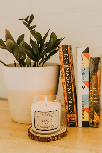 a candle and books on a table