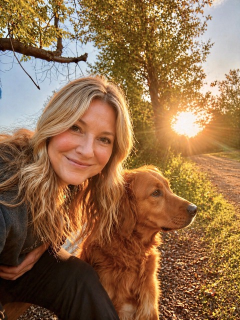 a woman and dog posing for a picture