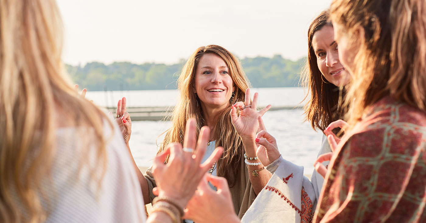 a group of women making hand gestures