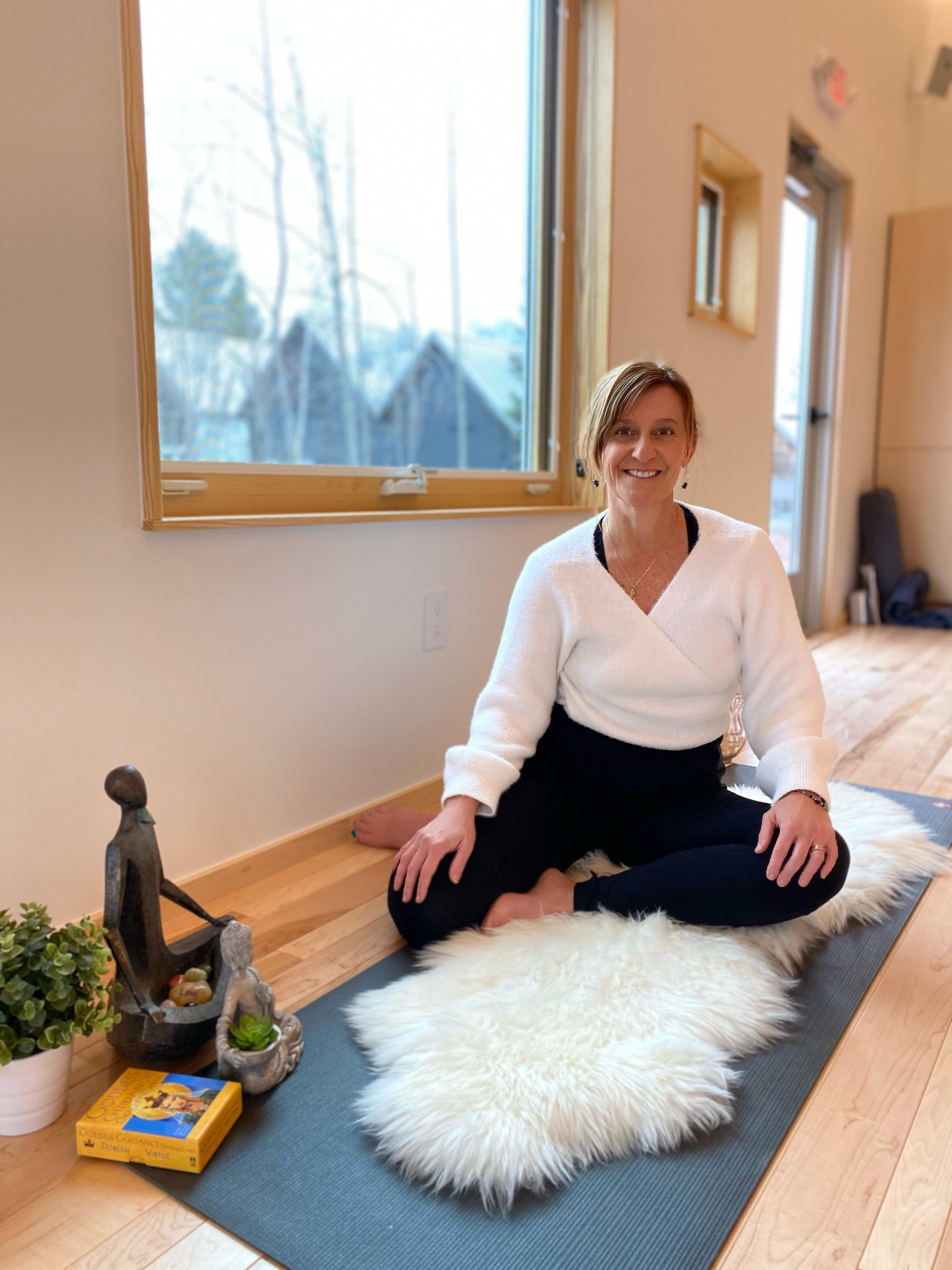 a woman sitting on a rug