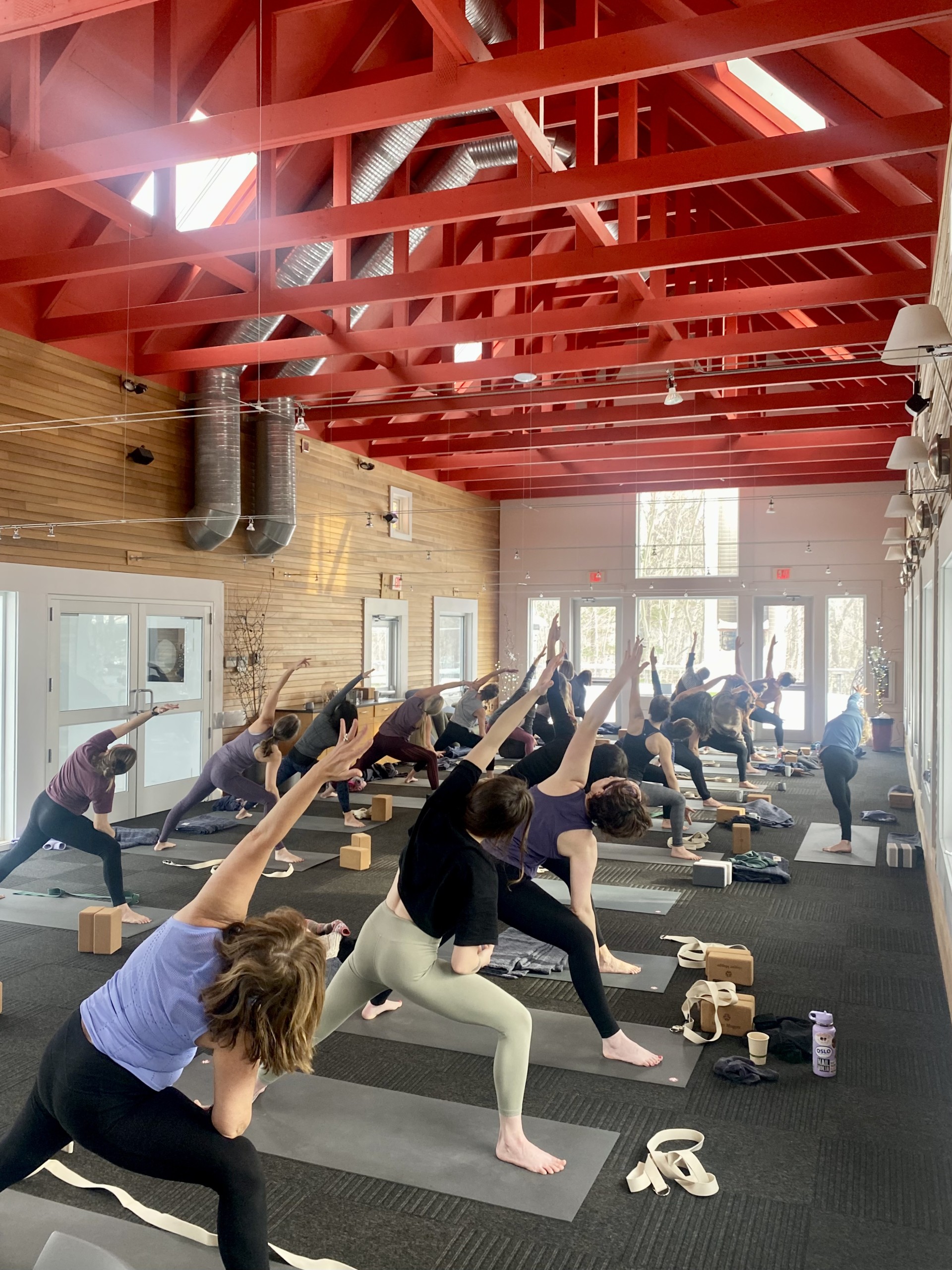 a group of people doing yoga in a room