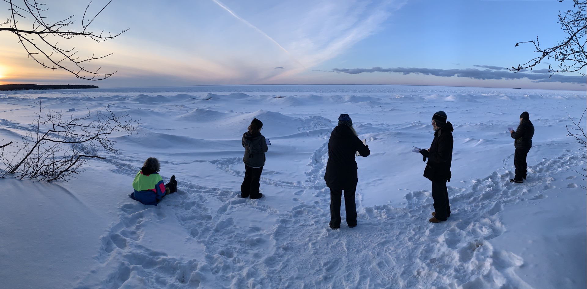 a group of people standing in the snow
