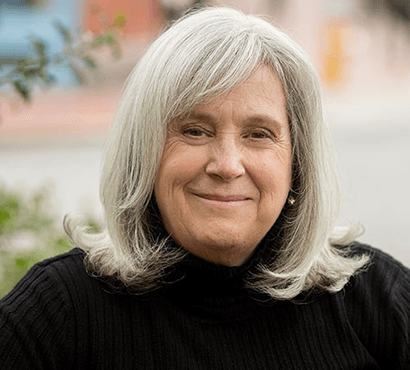 a woman with grey hair smiling