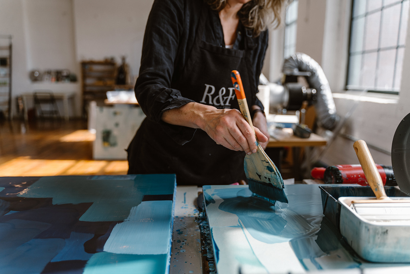 a woman painting a blue painting