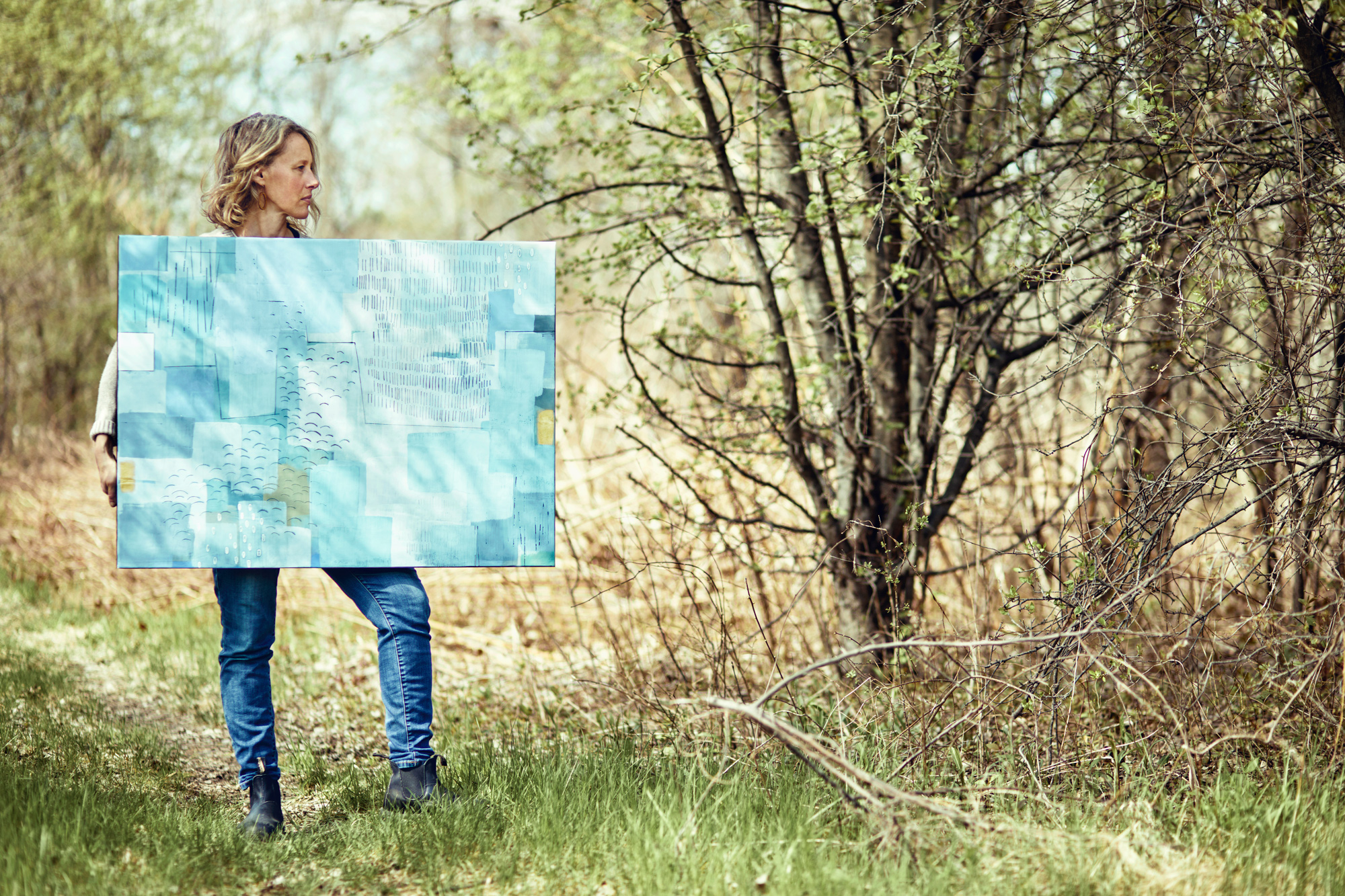 a woman holding a large piece of paper