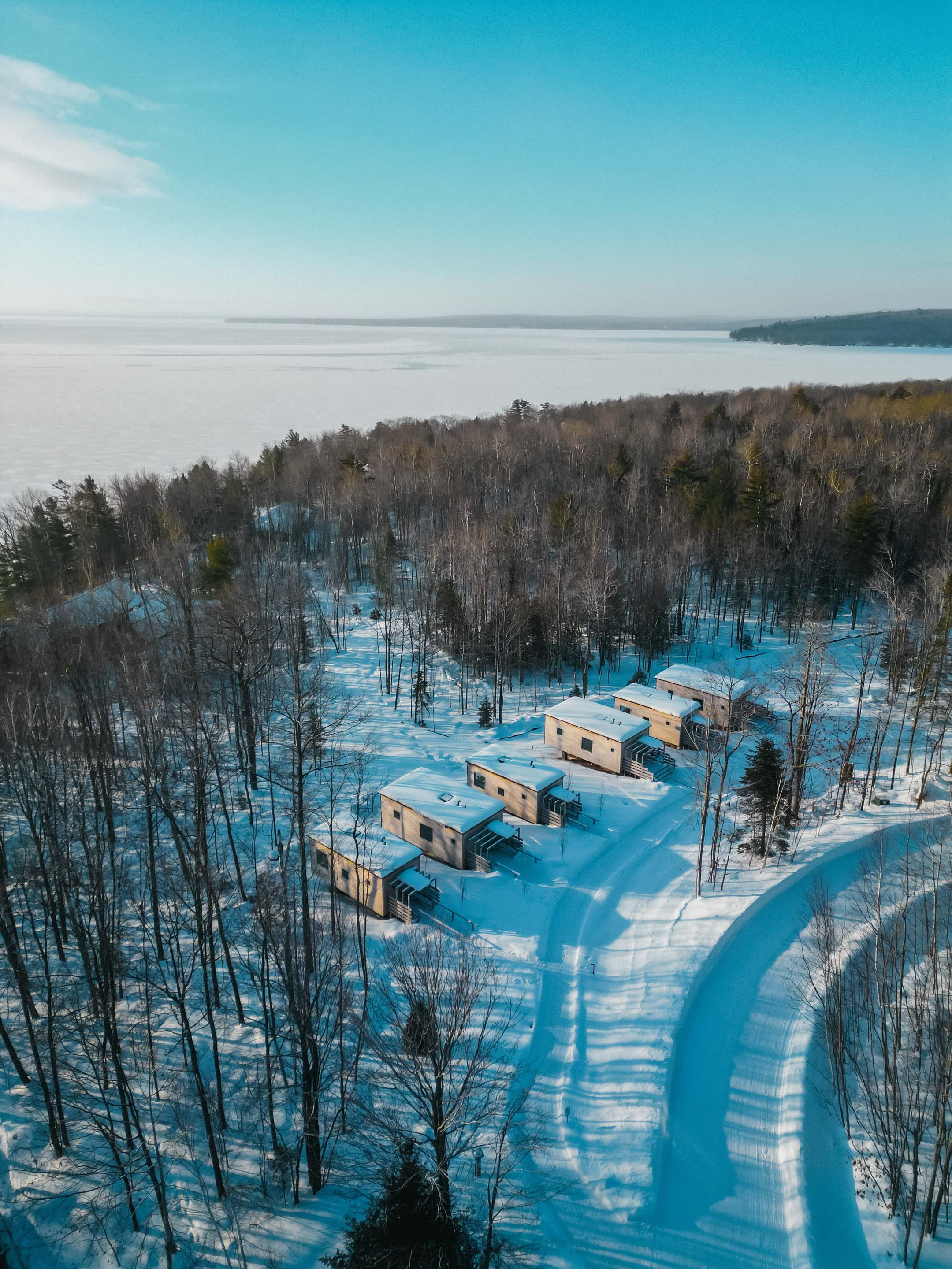 a snowy landscape with buildings and trees