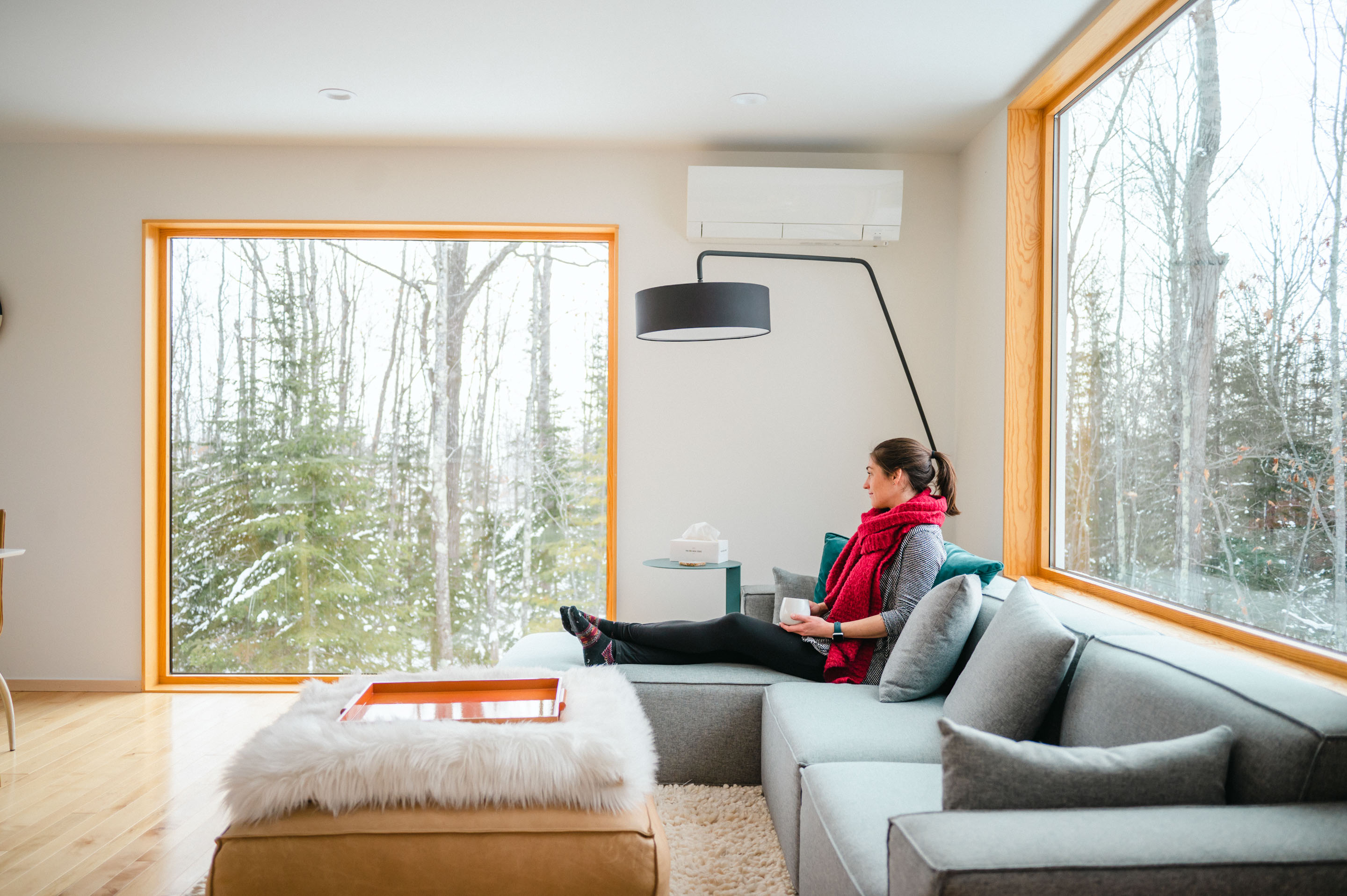 a woman sitting on a couch looking out a window