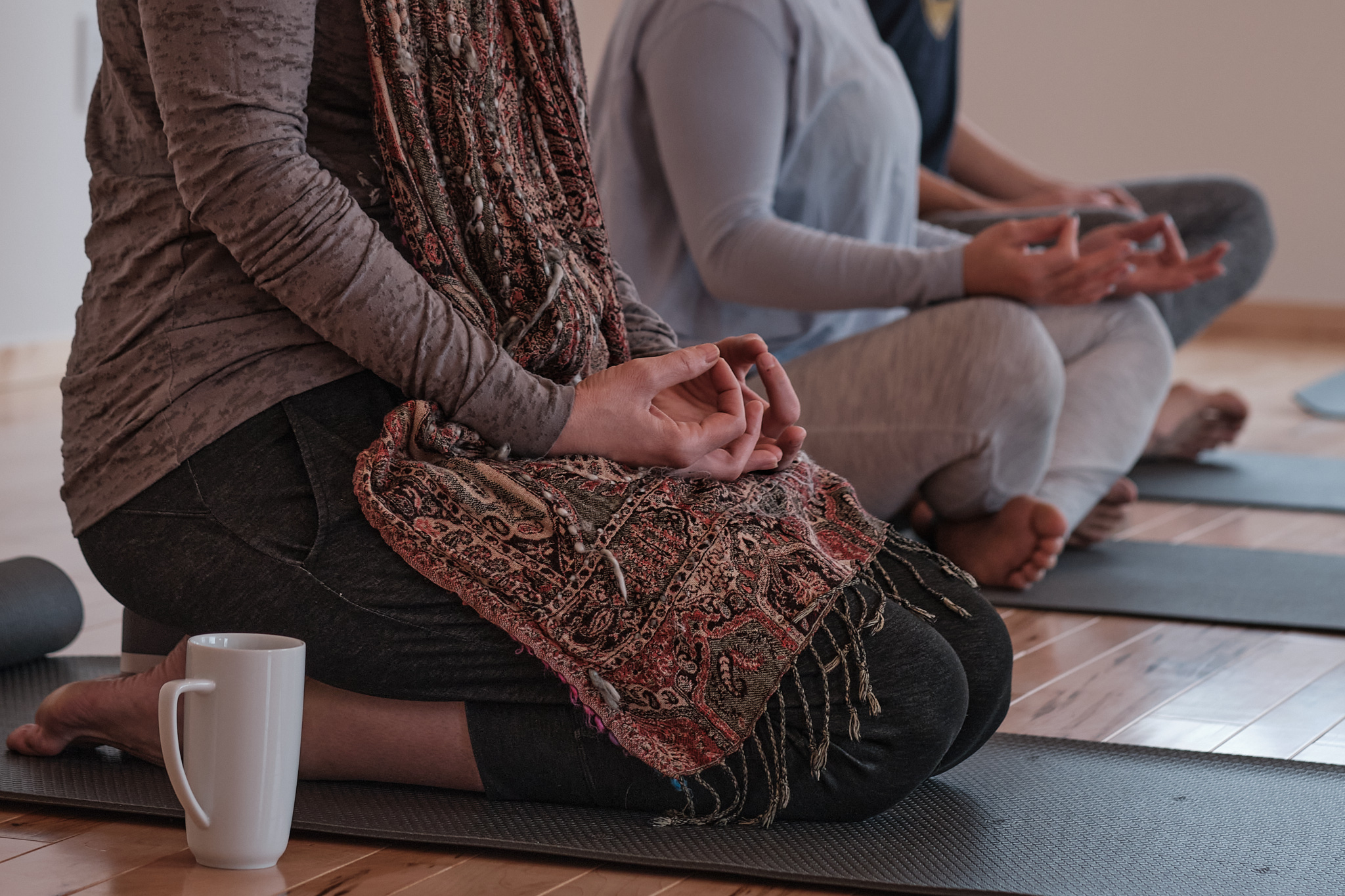 a group of people sitting on yoga mats