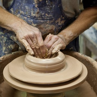 a close-up of a potter's hands