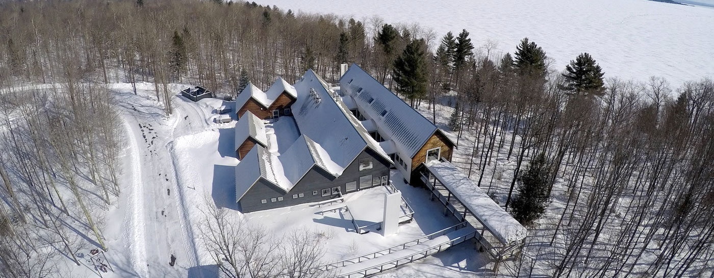 a group of houses in the snow light