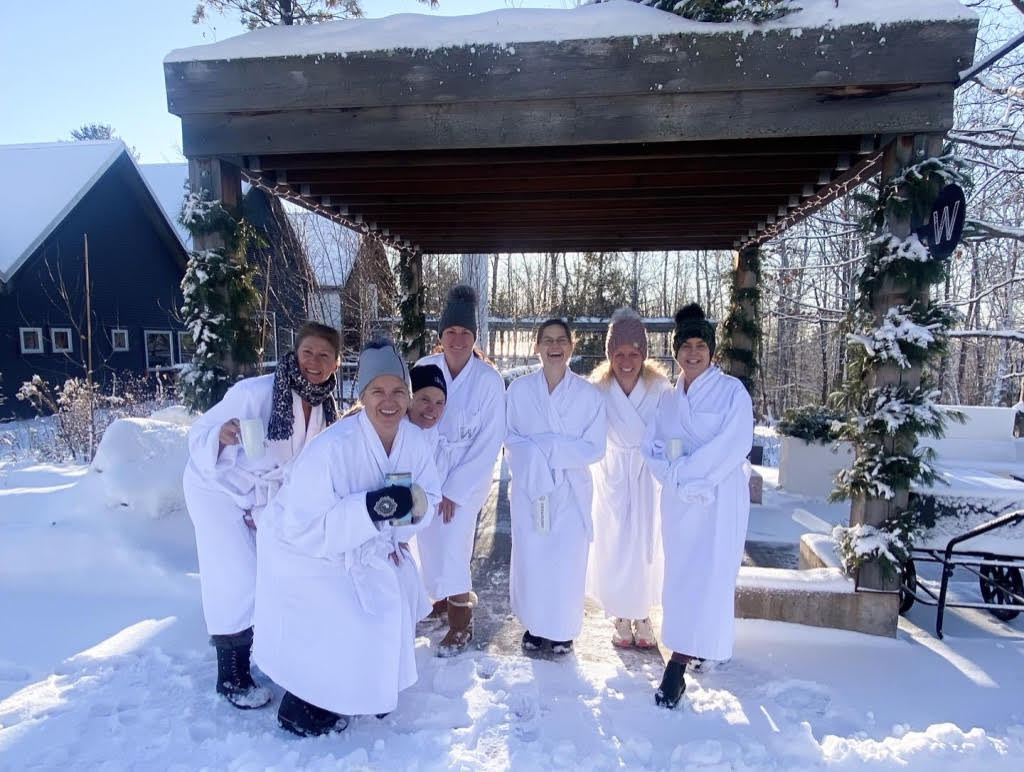 a group of women in white robes in the snow
