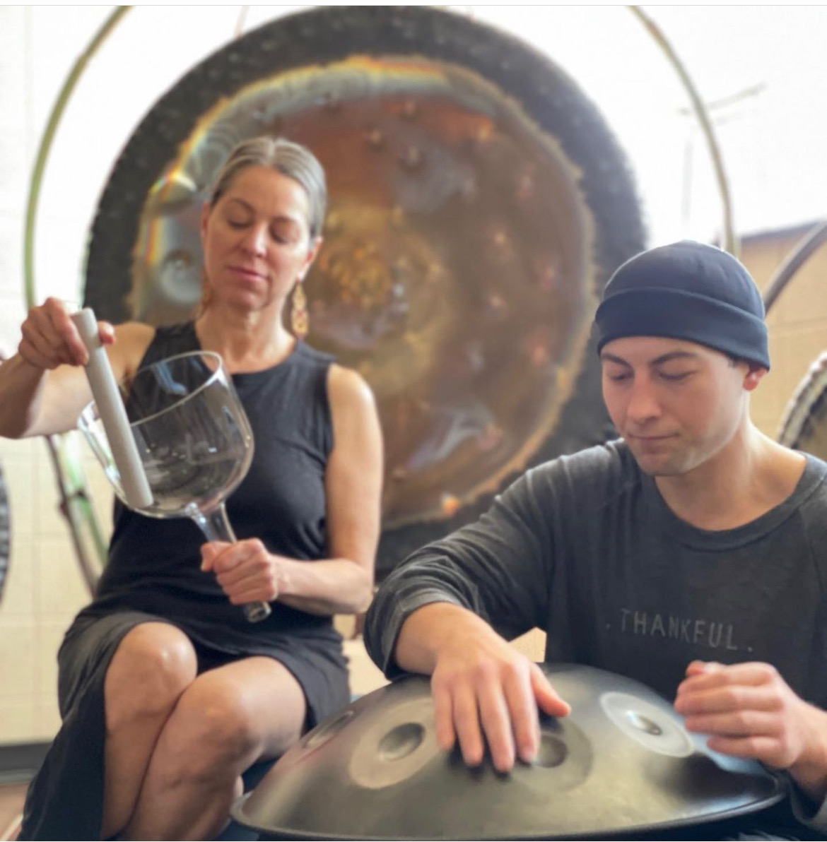 a man and woman playing drums
