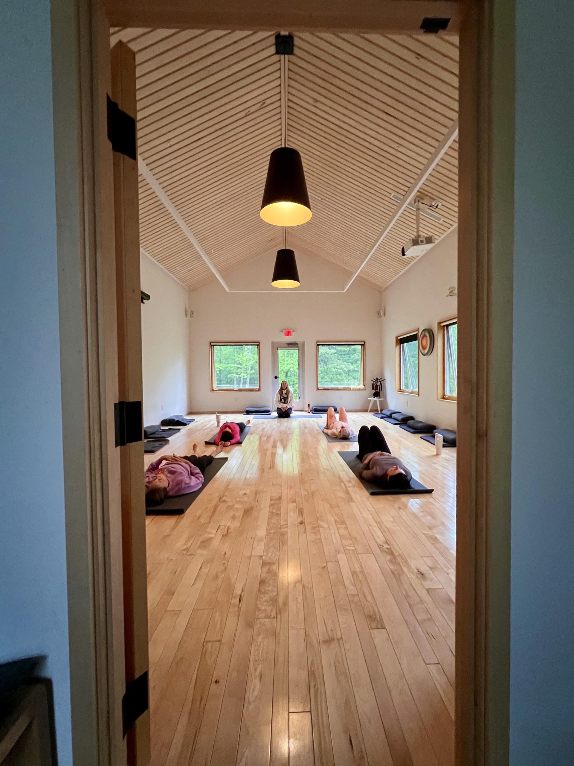 a group of people lying on mats in a room