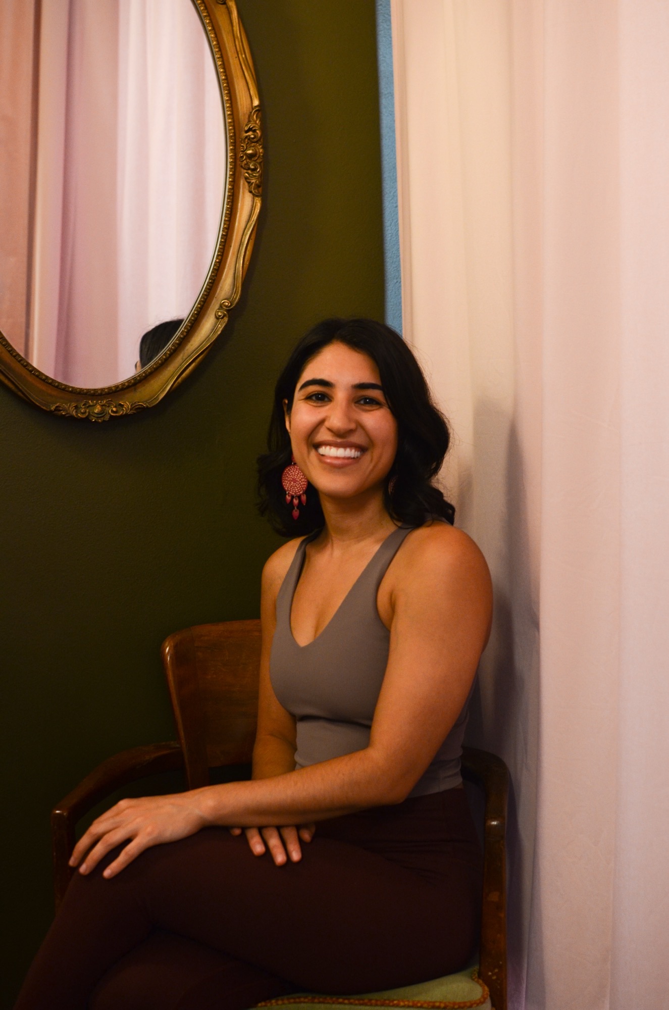 a woman sitting in a chair smiling