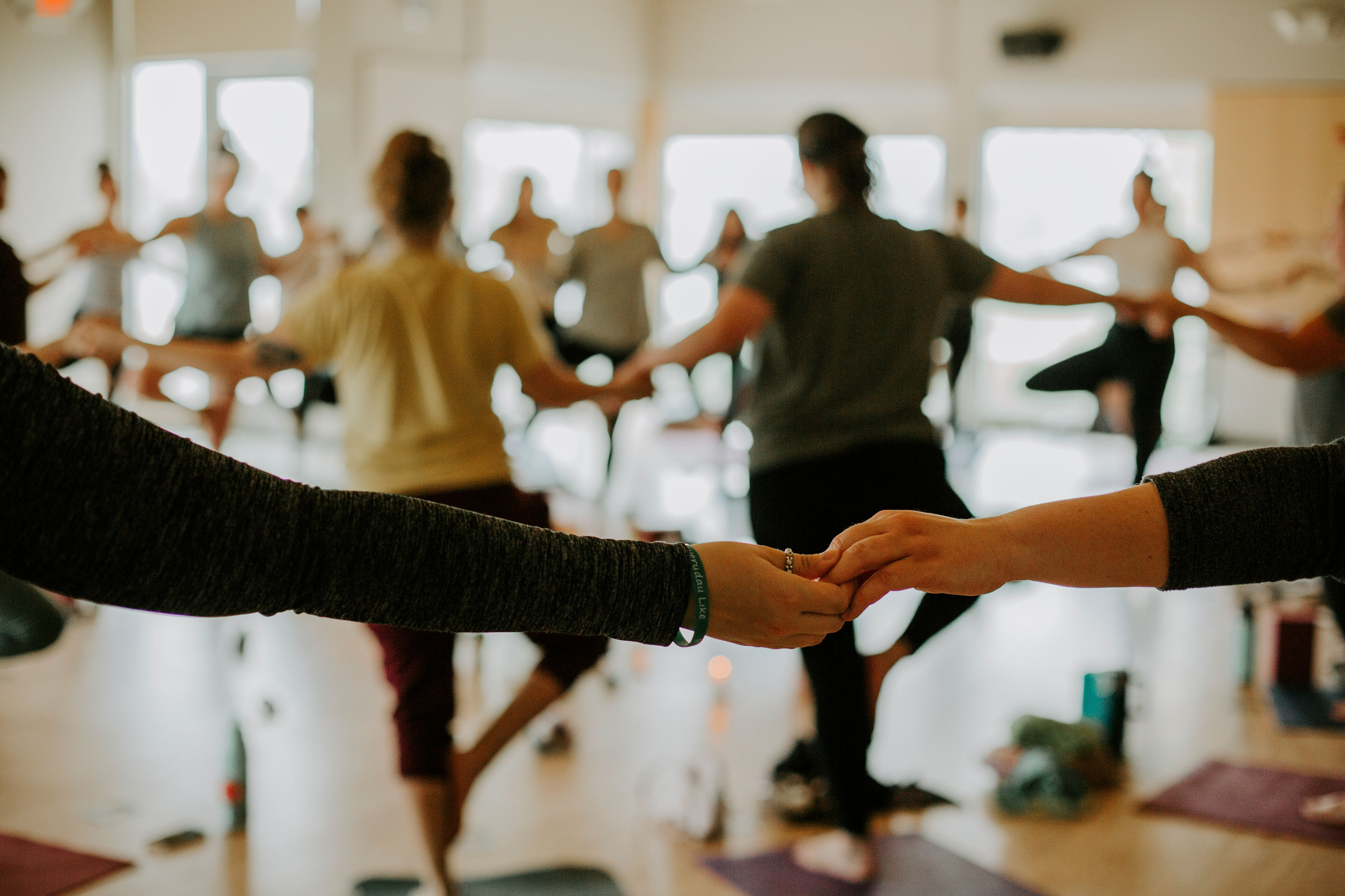 a group of people holding hands
