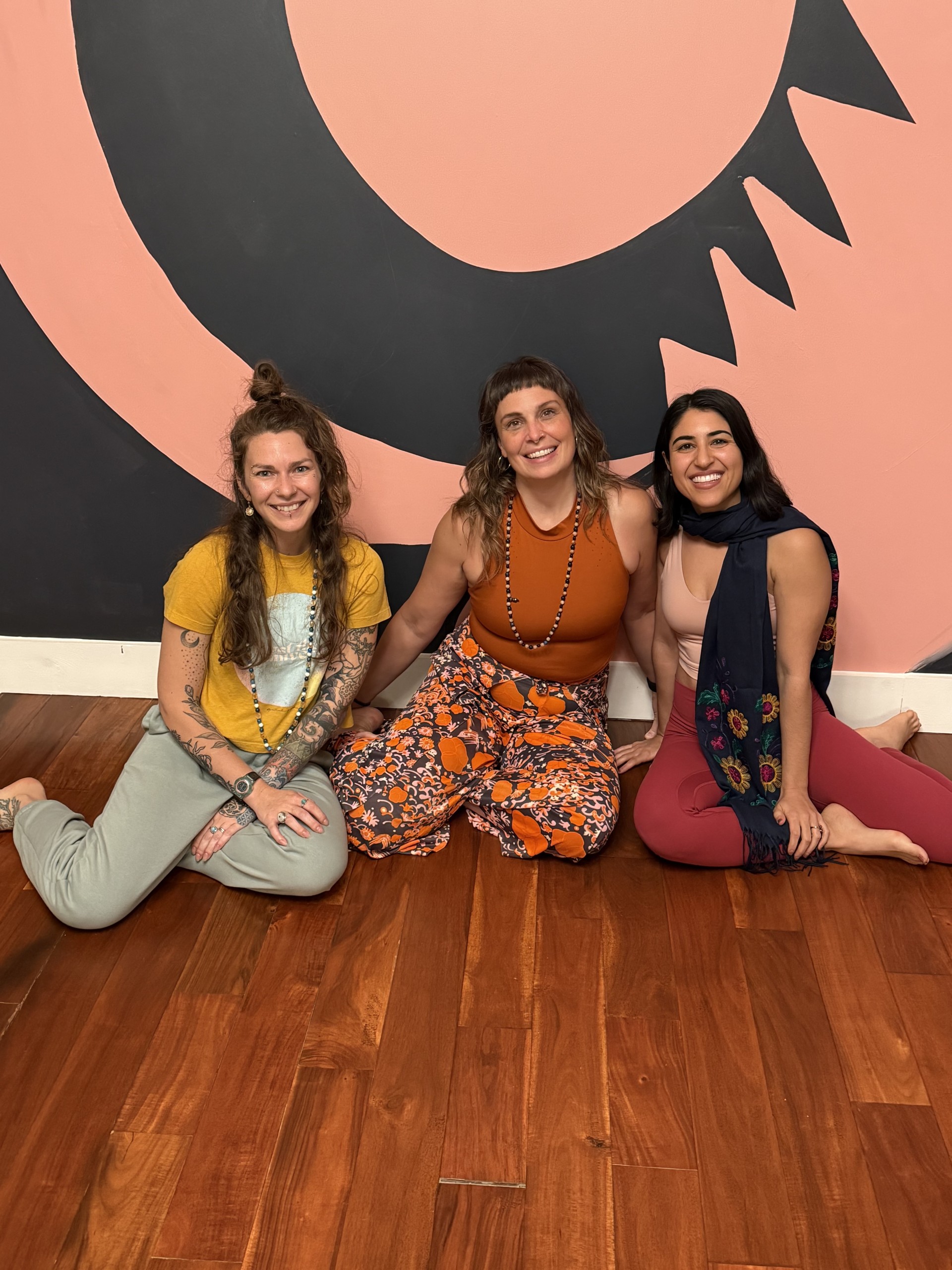 a group of women sitting on the floor