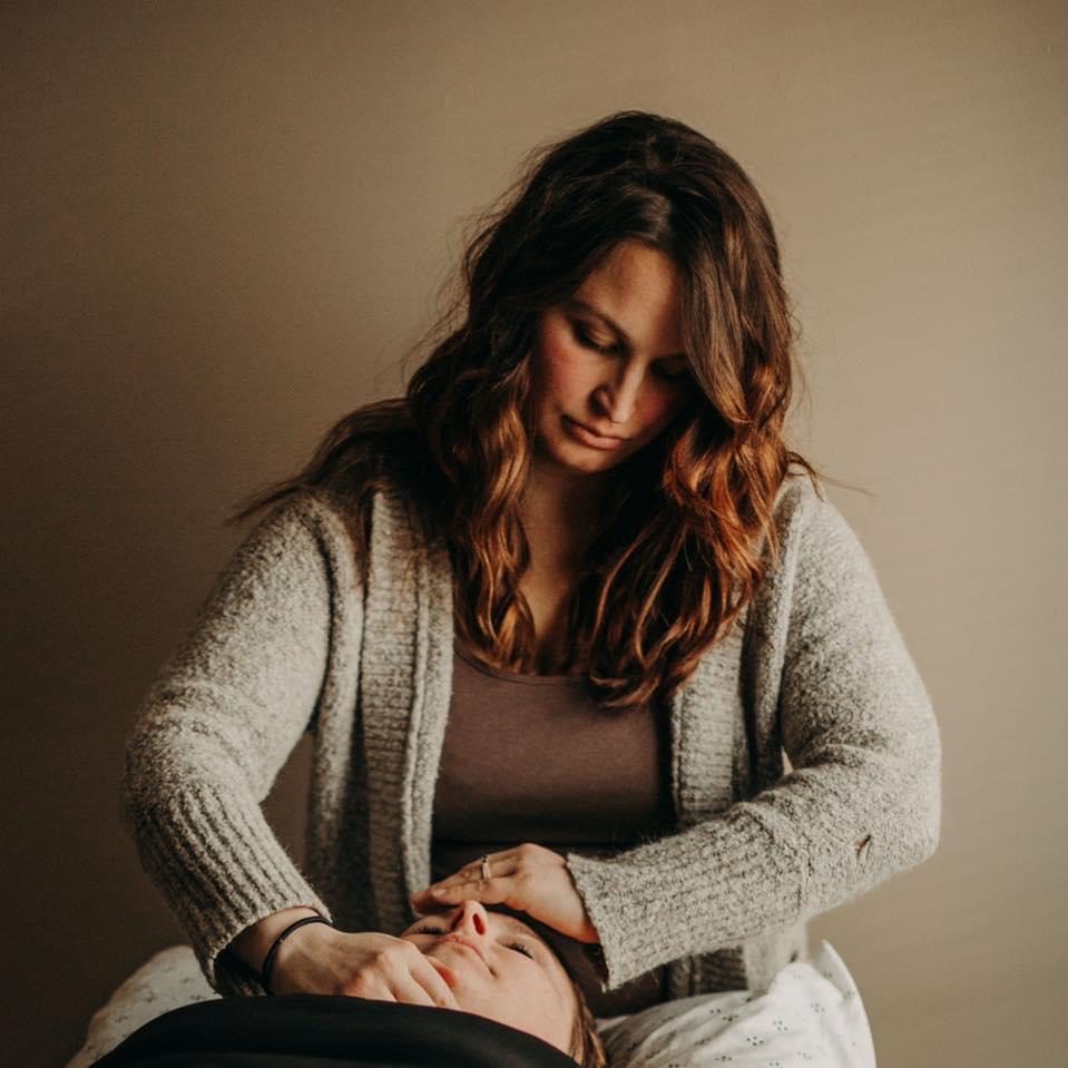 a woman massaging a man's face