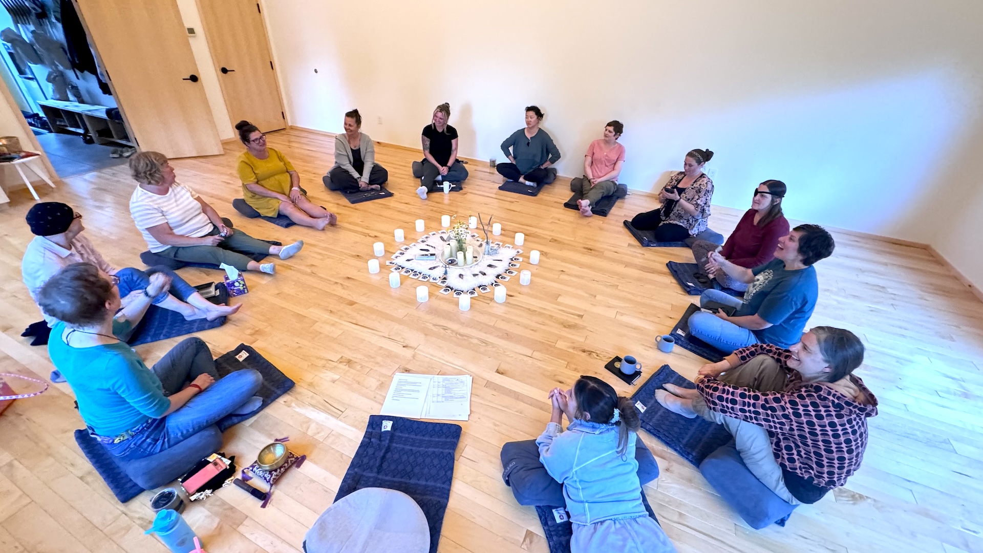 a group of people sitting on the floor in a circle