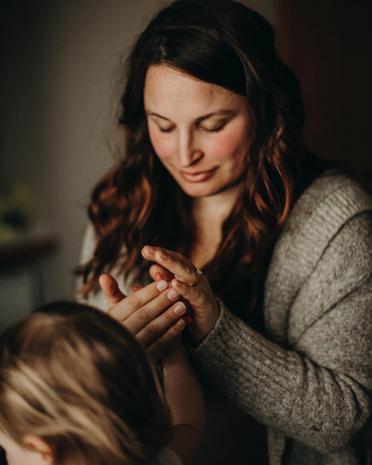 a woman touching a child's hand