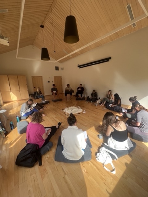 a group of people sitting on the floor in a circle