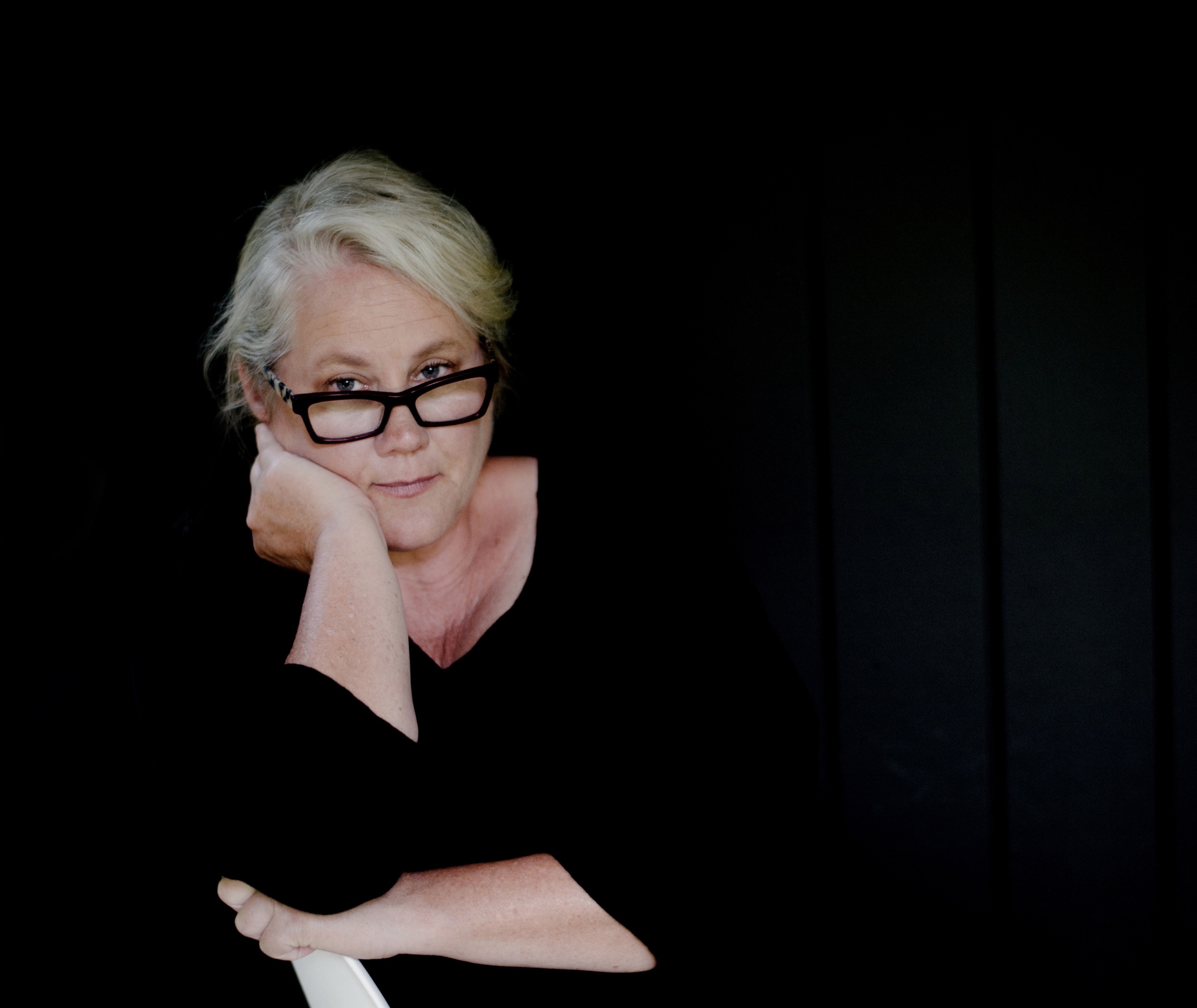 a woman with her hand on her chin