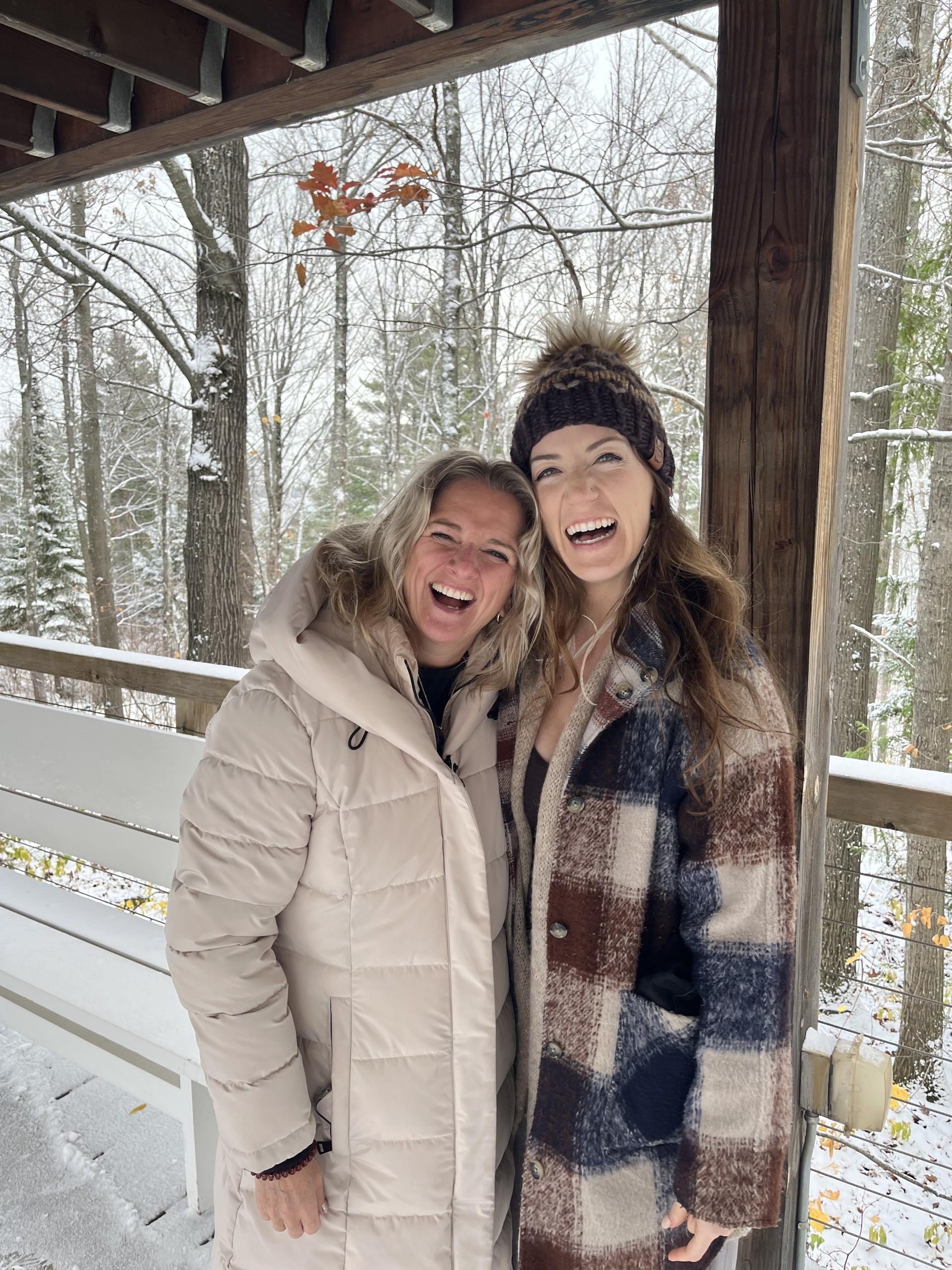 two women standing in the snow