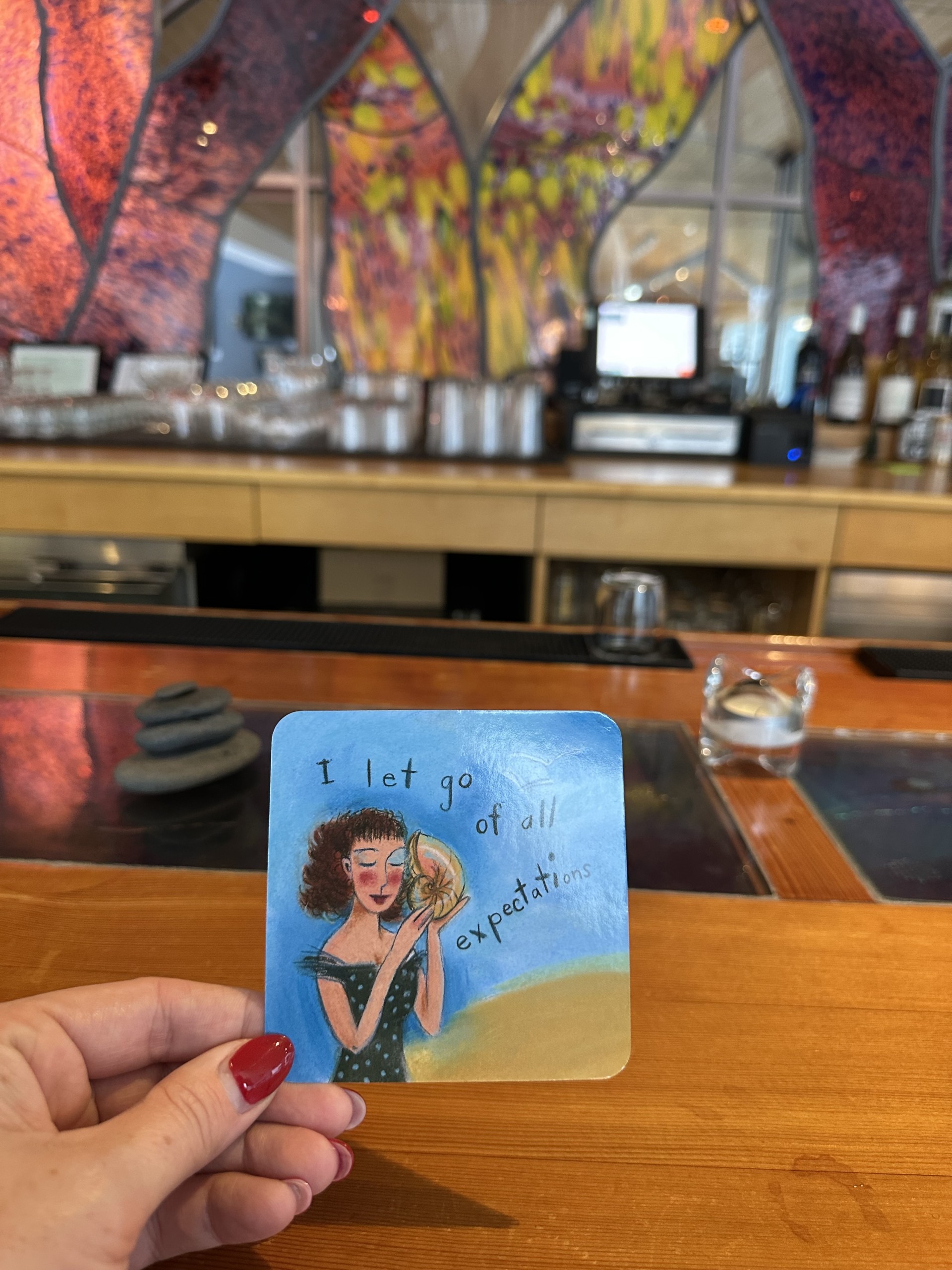 a hand holding a card with a drawing on it