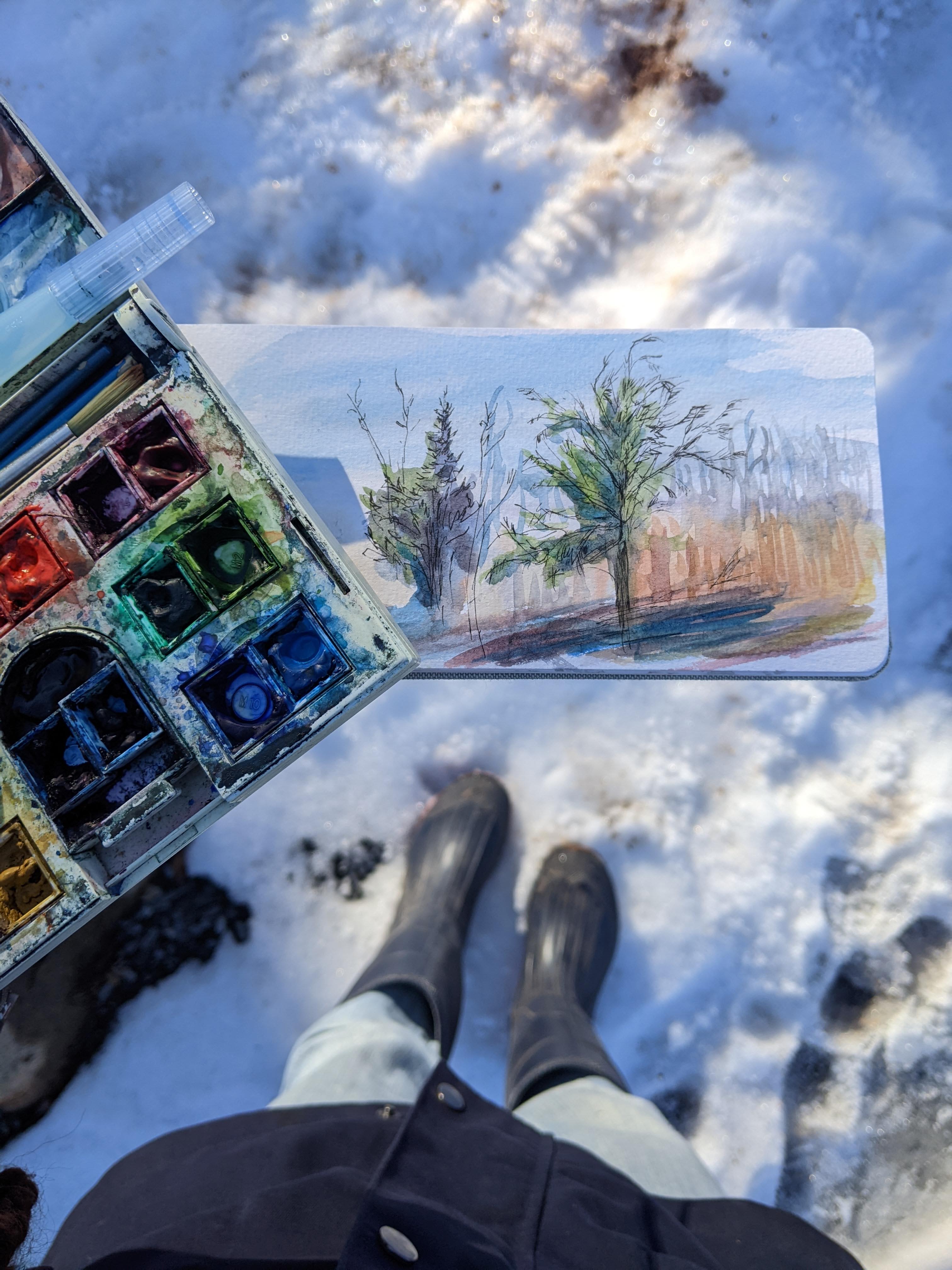 a painting on a paper with a brush and watercolors on it