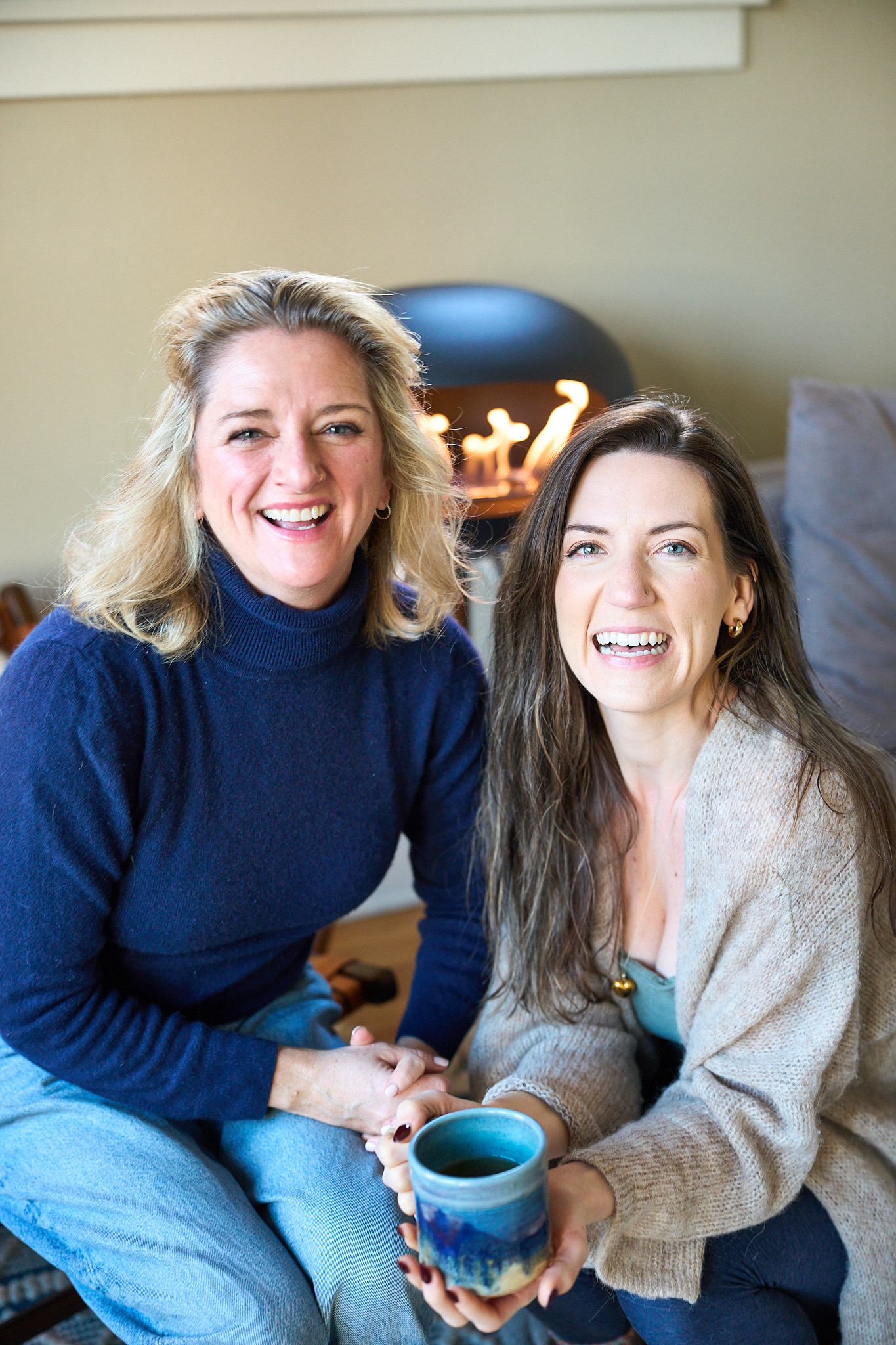 two women sitting on the floor smiling