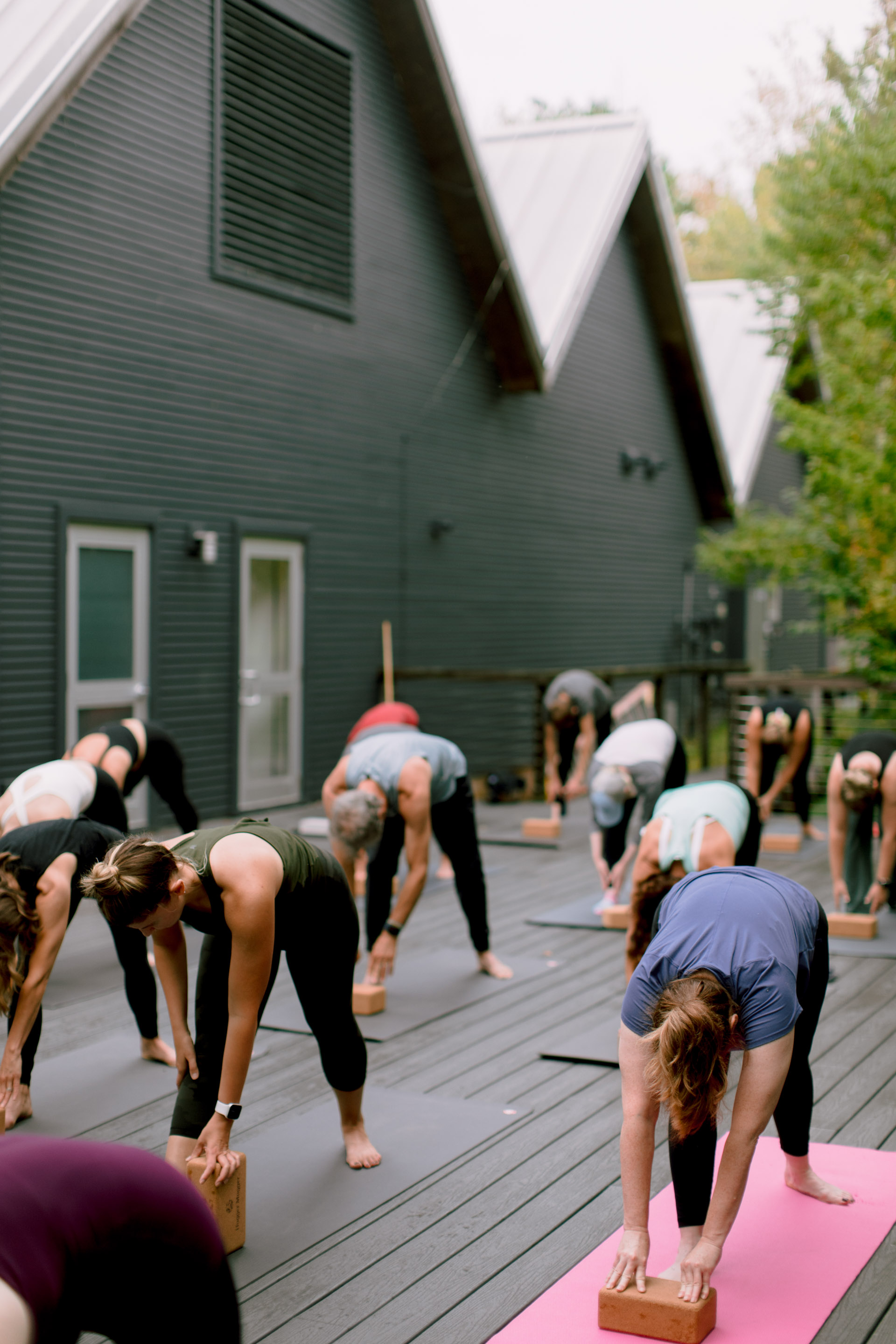 a group of people doing yoga outside