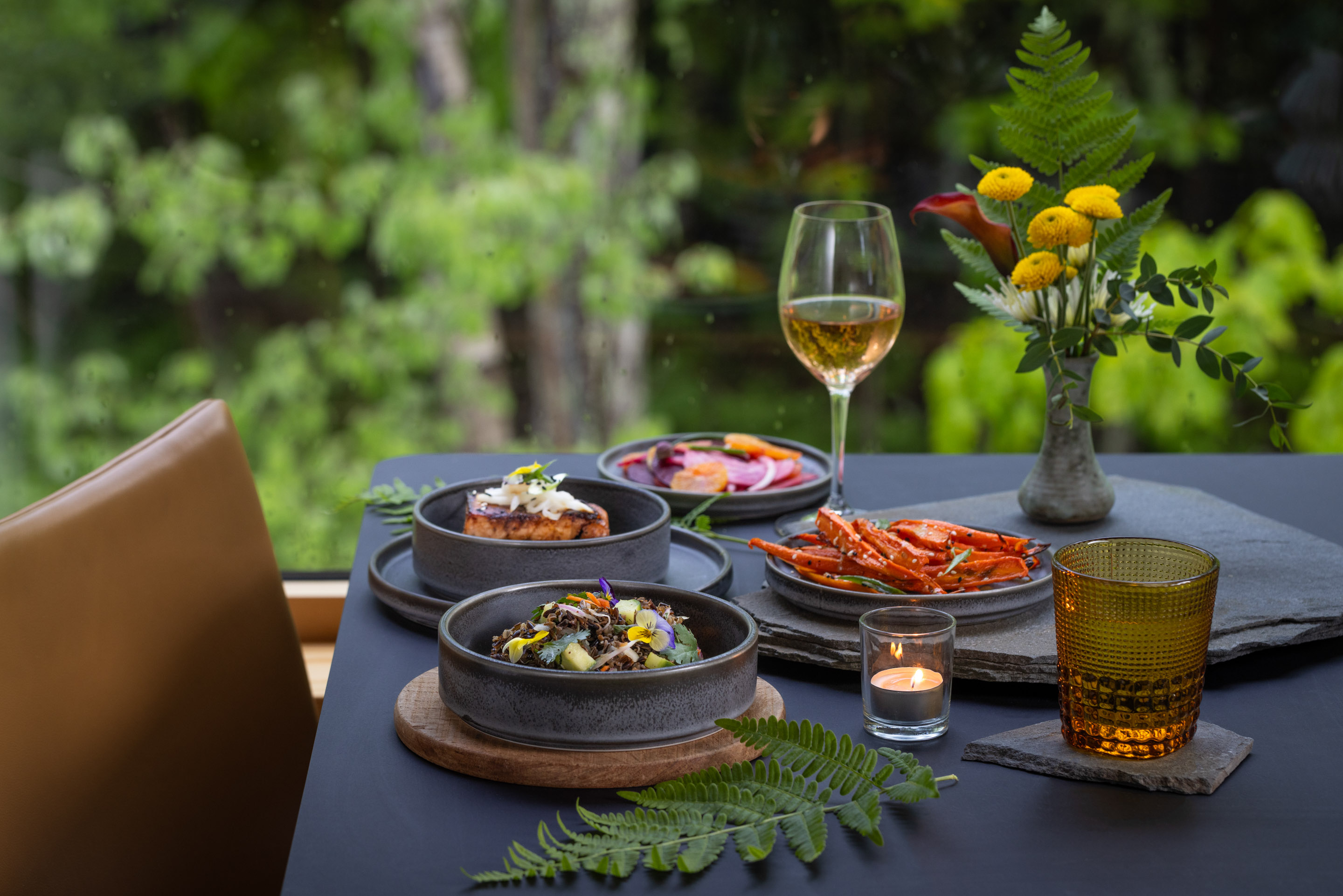 a table with plates of food and glasses of wine