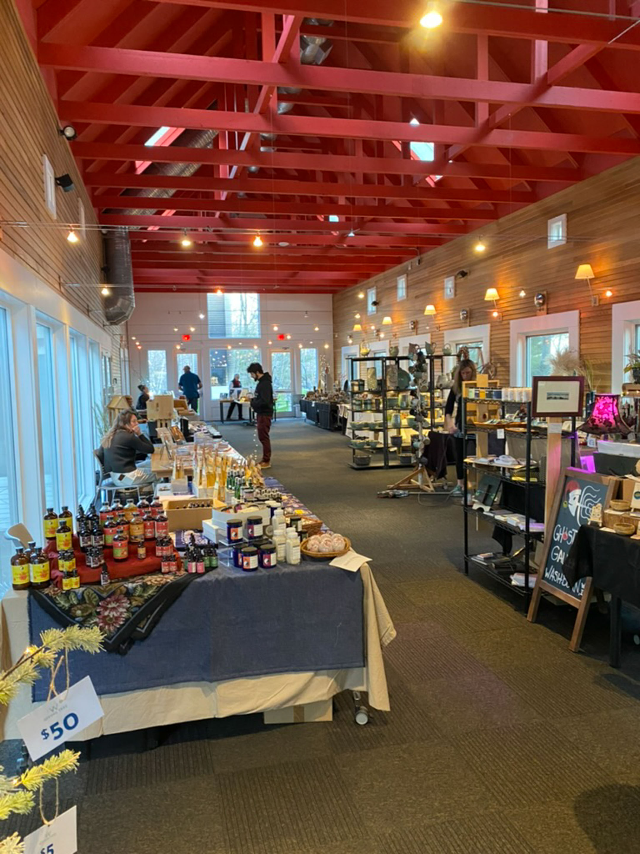 a room with a table with food items and people in it