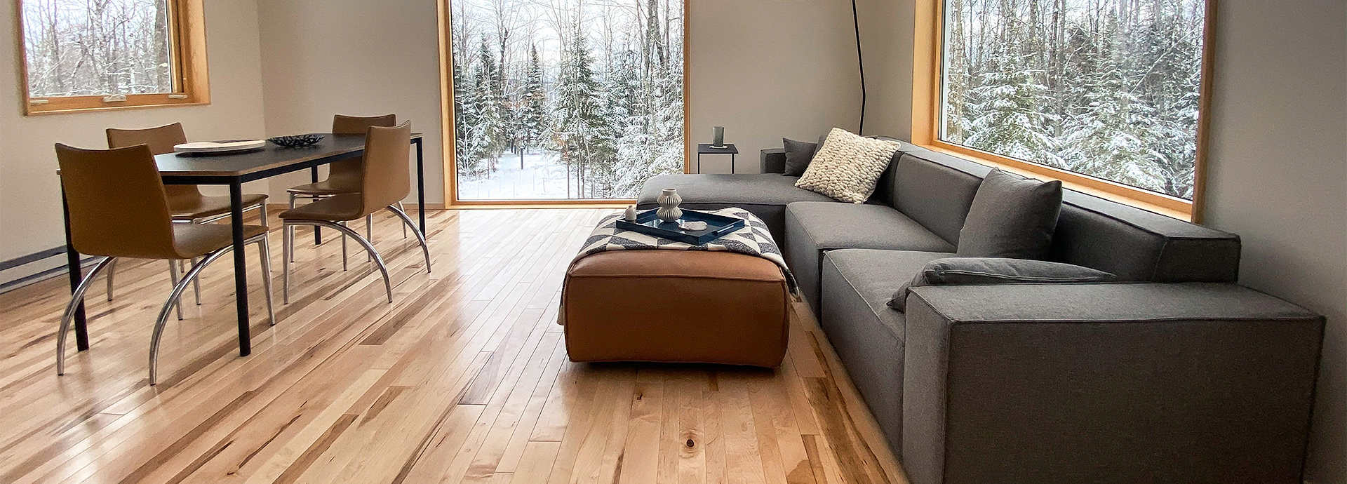 a living room with a large couch and a large window