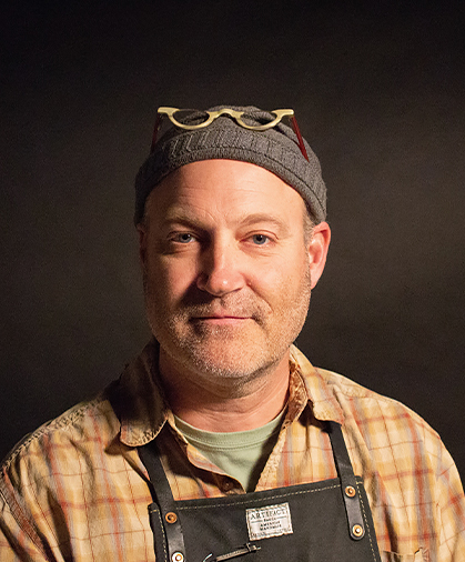 Portrait of a man wearing a wool cap and a plaid shirt