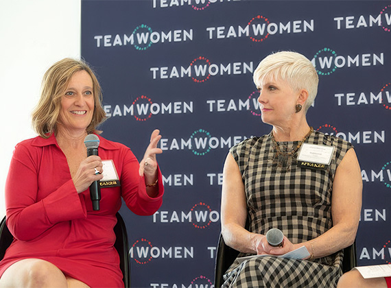 two women sitting in chairs talking