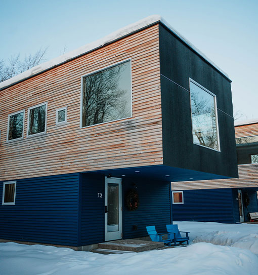 a two story house with a blue and white wall