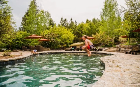 a man jumping into a pool