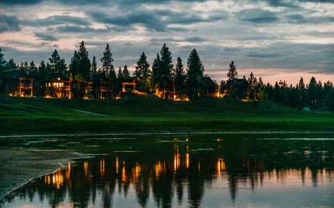a body of water with trees and buildings in the background