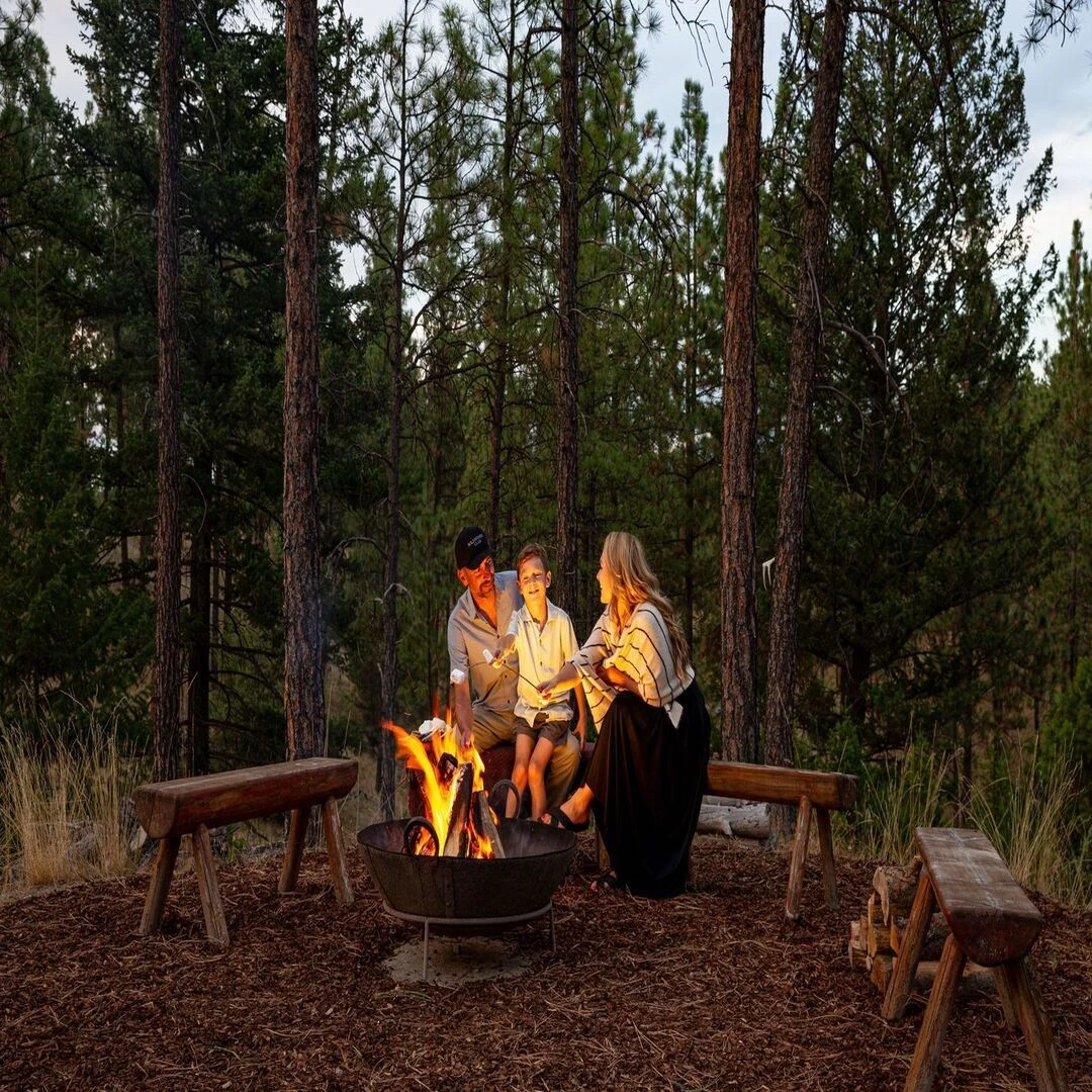 a group of people sitting around a fire