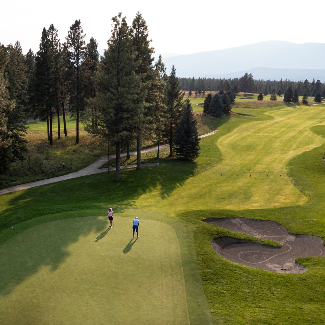 a couple of people on a golf course