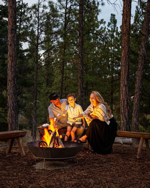 a man and woman sitting around a fire pit