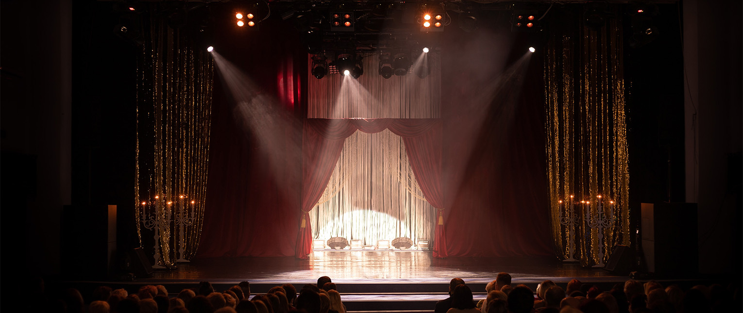a stage with red curtains and lights