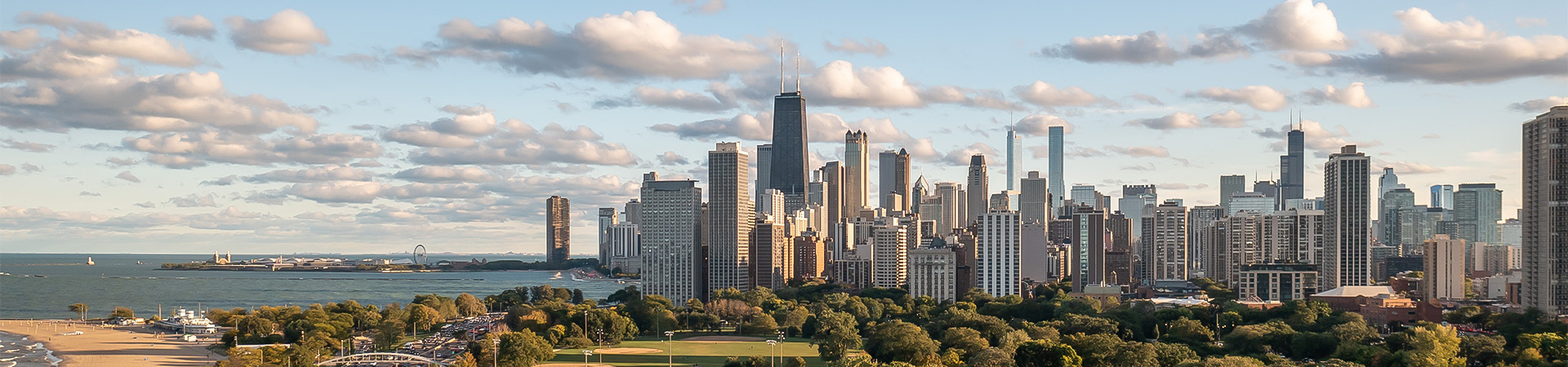 a city skyline with trees and water