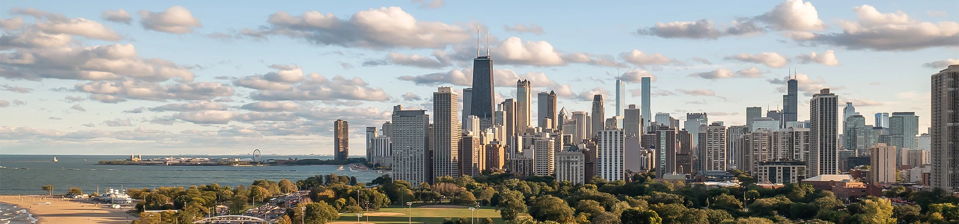 a city skyline with trees and water